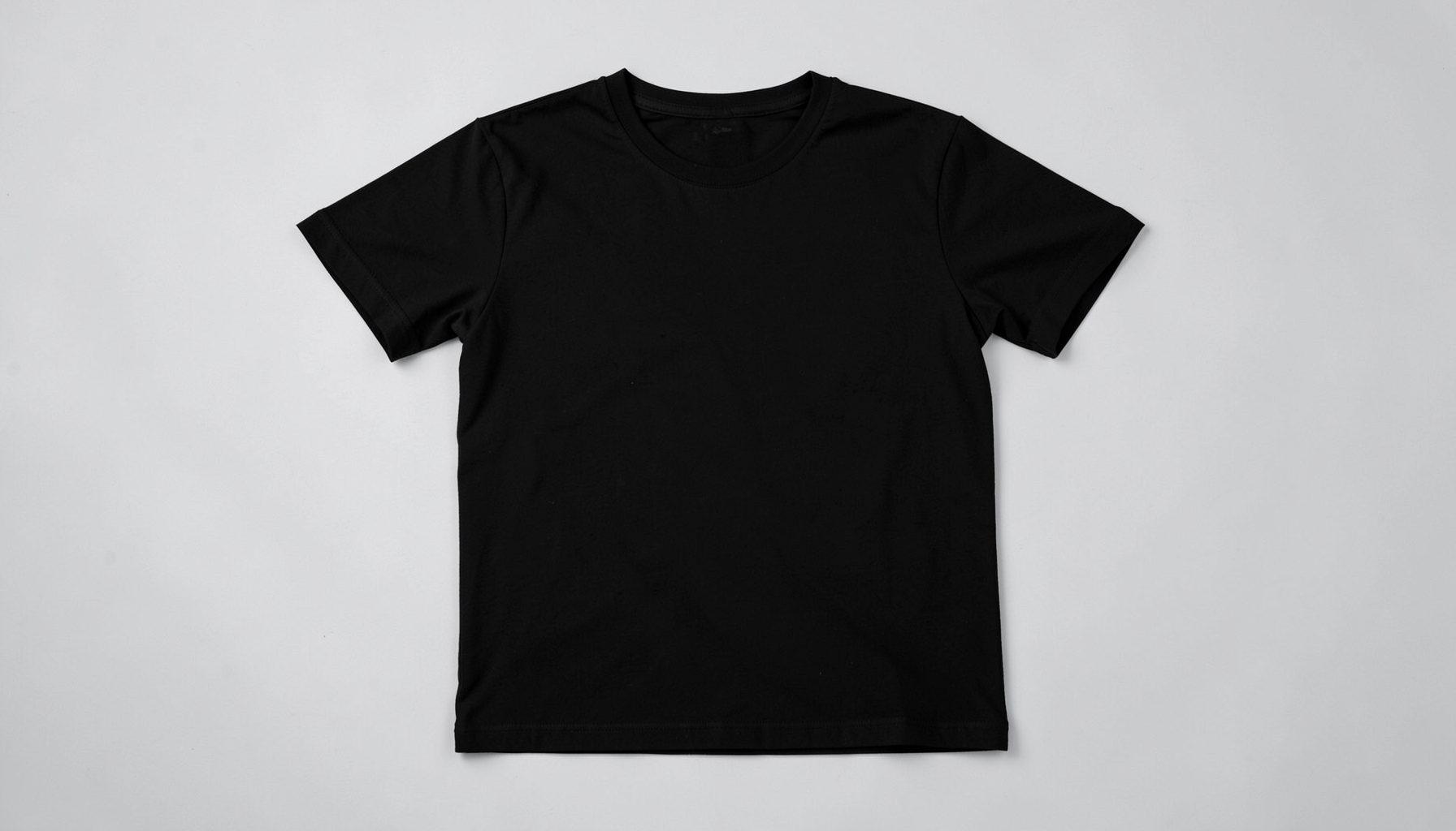 Black hoodie laid flat, minimal dark streetwear essential