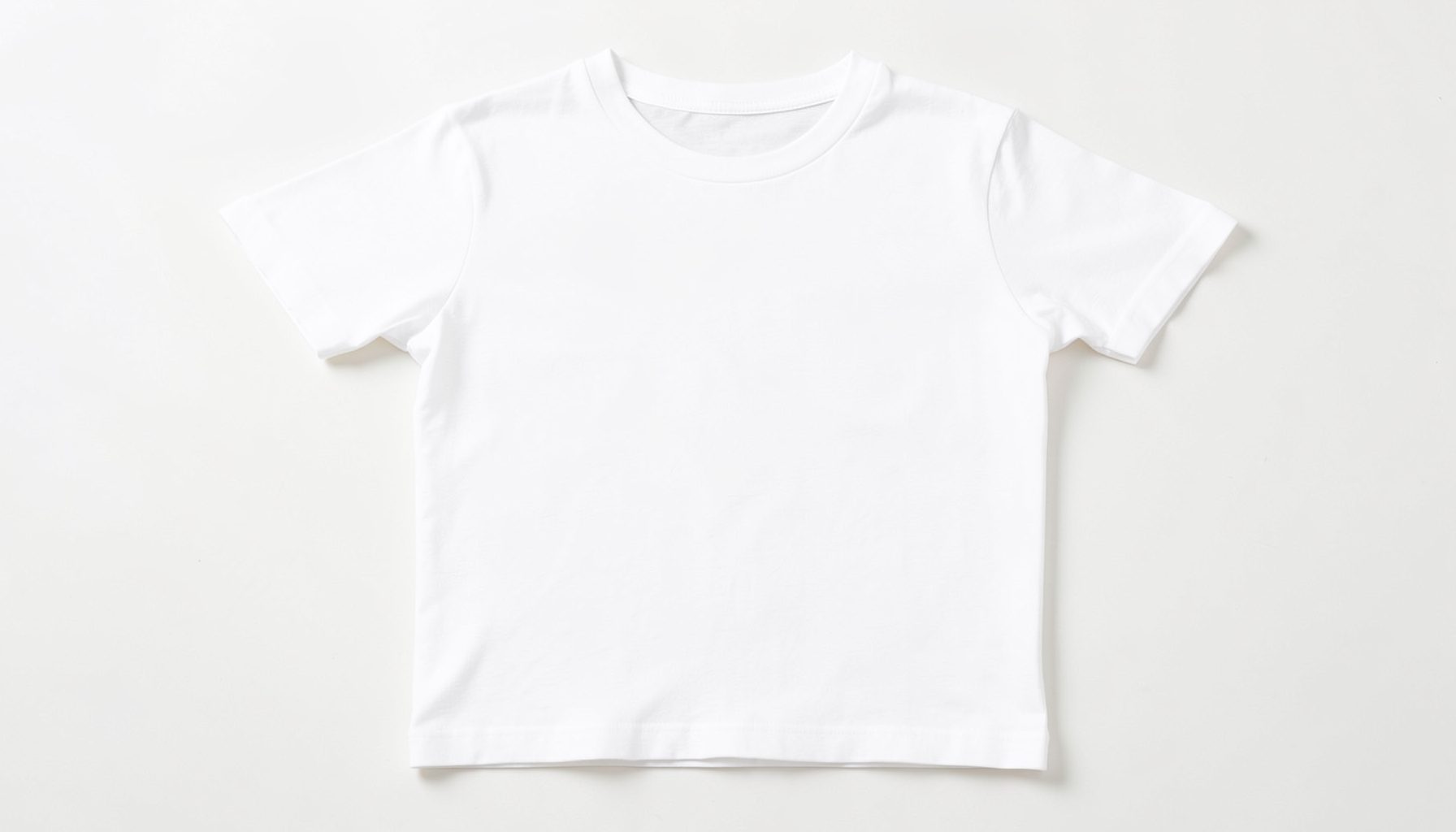 Plain white short-sleeve t-shirt laid flat on a clean light surface, bright and minimal